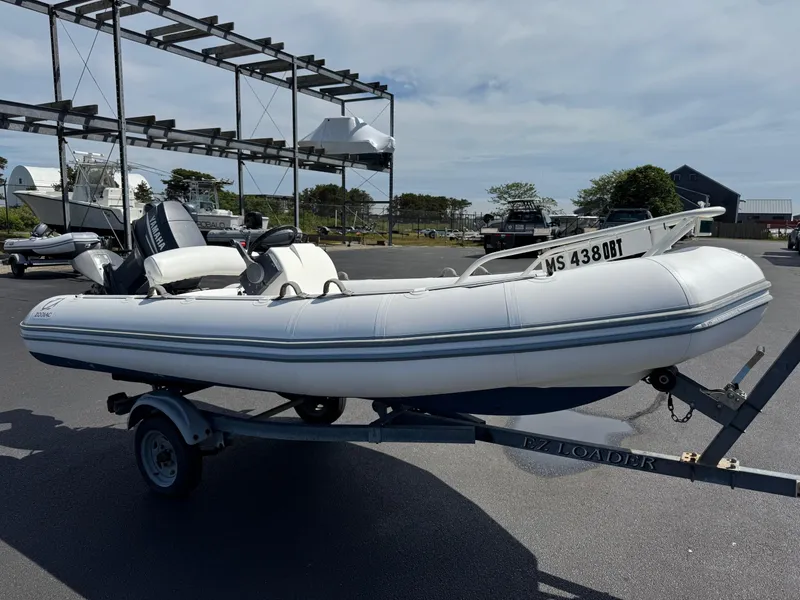 Slide: The Image of Inflatable Zodiac YL 420 DL boat on trailer, parked outdoors, sunny day. - 3