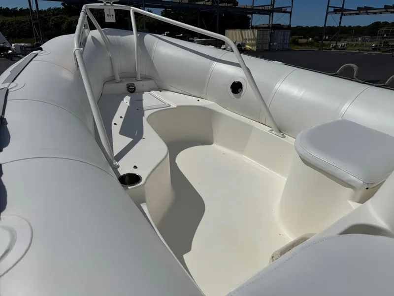 Slide: The Image of Interior view of a 2000 Zodiac YL 420 DL inflatable boat, featuring white seating and railings. - 6