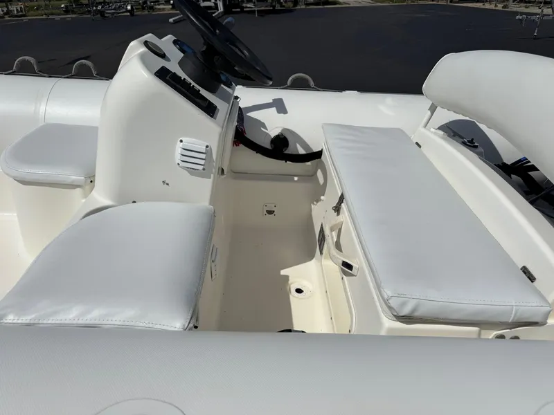 Slide: The Image of Interior of a 2000 Zodiac YL 420 DL boat with white seating and steering console. - 7