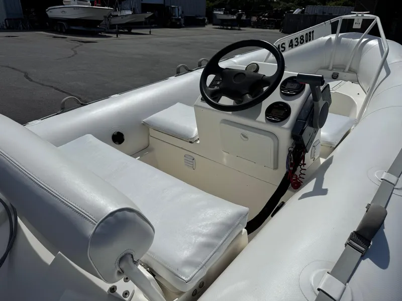 Slide: The Image of 2000 Zodiac YL 420 DL inflatable boat interior with steering console and seating. - 8