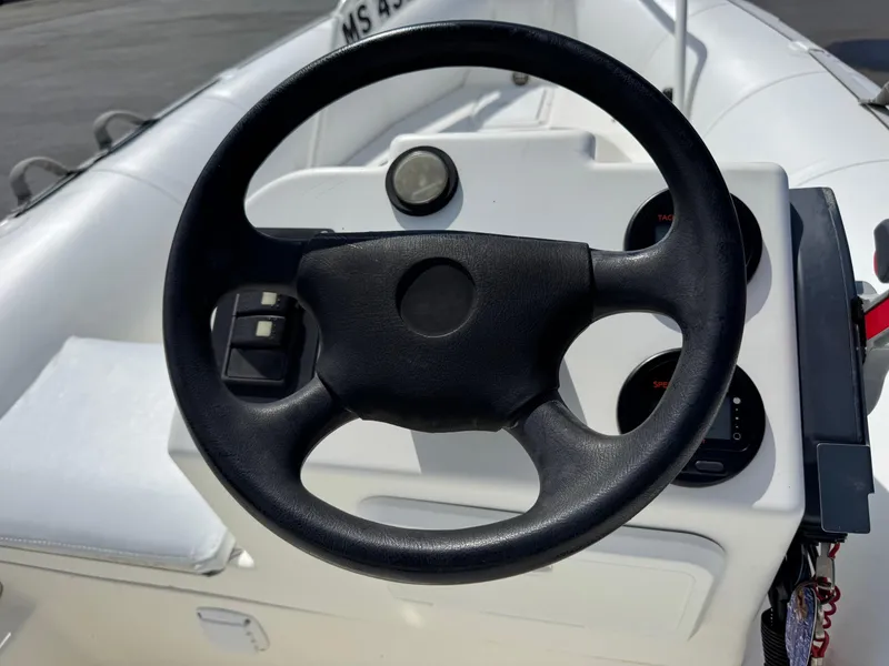 Slide: The Image of Steering wheel of a 2000 Zodiac YL 420 DL inflatable boat, featuring dashboard controls. - 9