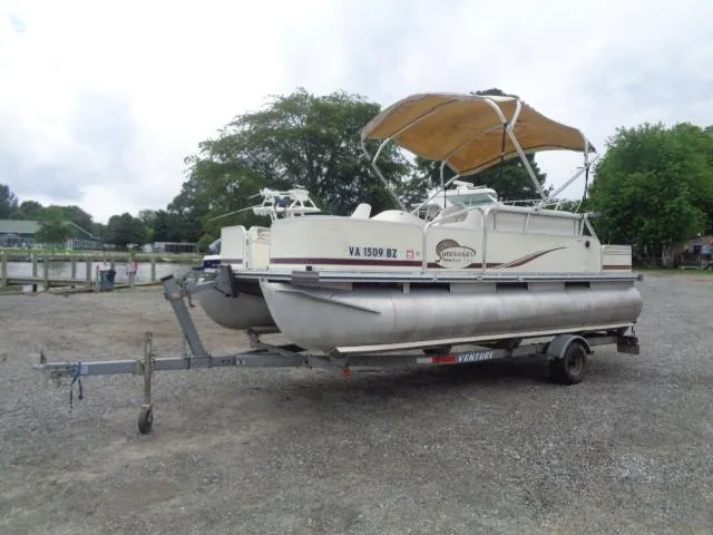 The Image of 2002 Lowe Suncruiser Trinidad 184 pontoon boat on trailer, parked outdoors. - 1