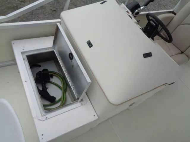 Slide: The Image of 2002 Lowe Suncruiser Trinidad 184 boat console with open storage compartment. - 13