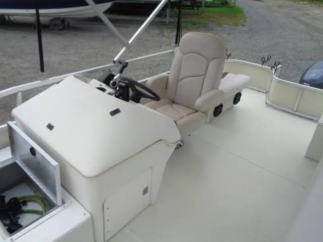 Slide: The Image of 2002 Lowe Suncruiser Trinidad 184 boat interior with steering console and seating. - 14