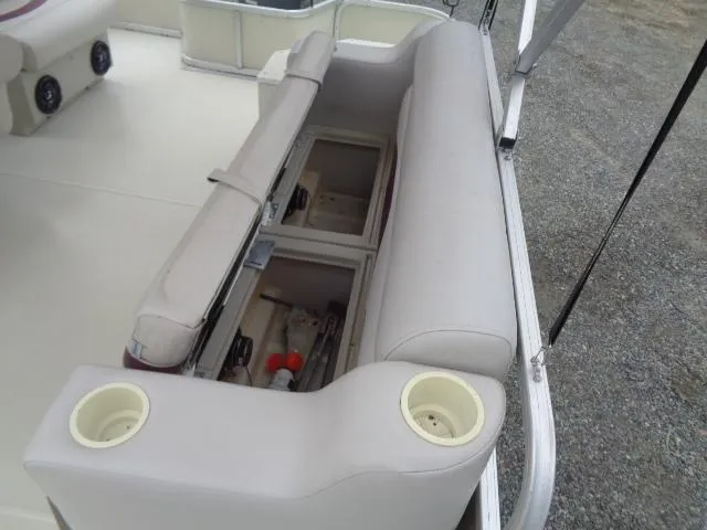 Slide: The Image of 2002 Lowe Suncruiser Trinidad 184 boat interior with open storage compartments and cup holders. - 15
