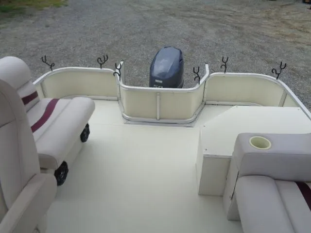 Slide: The Image of 2002 Lowe Suncruiser Trinidad 184 pontoon boat interior with seating and motor. - 16