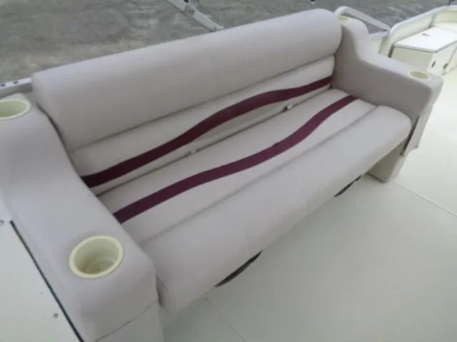 Slide: The Image of 2002 Lowe Suncruiser Trinidad 184 boat seat with cup holders and maroon accents. - 18