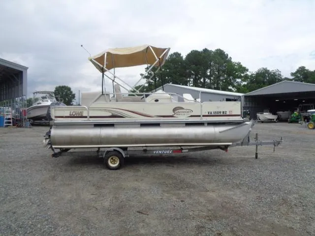 Slide: The Image of 2002 Lowe Suncruiser Trinidad 184 pontoon boat on trailer, parked outdoors. - 8