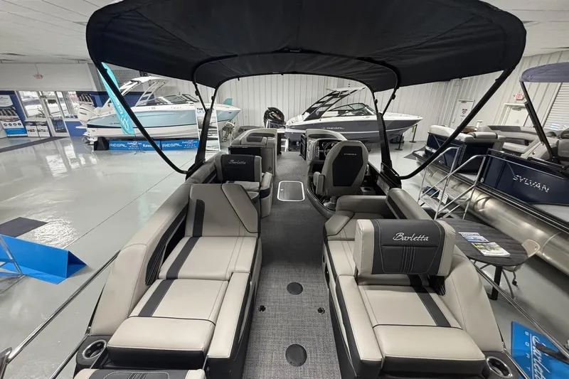 Slide: The Image of 2026 Barletta Corsa boat interior with luxurious seating and canopy in showroom. - 4
