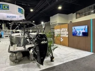 Slide: The Image of 2023 South Bay 25Sport RS9 DC 3.0+ boat displayed at an indoor exhibition. - 3