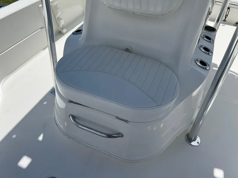 Slide: The Image of 2011 NauticStar 2200 Tournament boat seat with rod holders and stainless steel handle. - 10