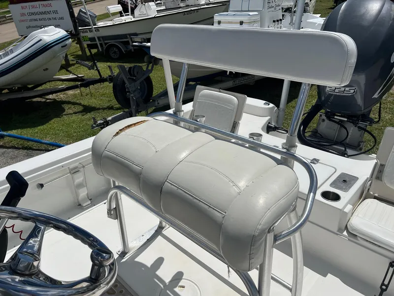 Slide: The Image of 2011 NauticStar 2200 Tournament boat interior with white seating and steering wheel. - 13