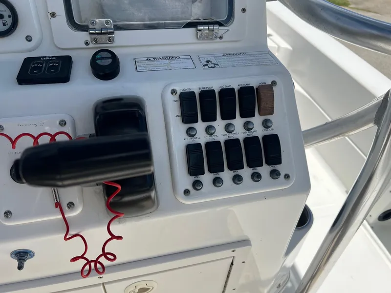 Slide: The Image of Control panel of a 2011 NauticStar 2200 Tournament boat with switches and throttle. - 15