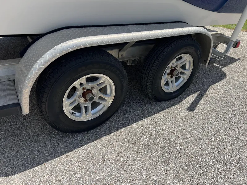 Slide: The Image of Trailer wheels of a 2011 NauticStar 2200 Tournament boat on a sunny day. - 2