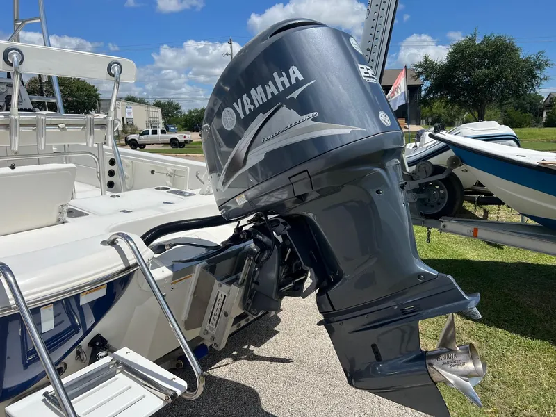 Slide: The Image of 2011 NauticStar 2200 Tournament boat with Yamaha outboard motor, parked outdoors. - 4