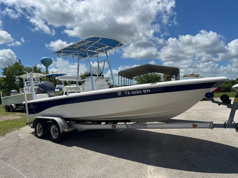 Slide: The Image of 2011 NauticStar 2200 Tournament boat on trailer under a partly cloudy sky. - 6