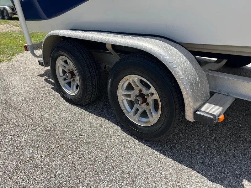 Slide: The Image of Trailer wheels of a 2011 NauticStar 2200 Tournament boat on asphalt. - 7