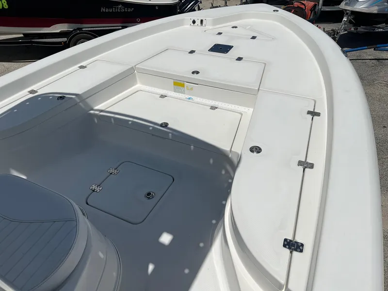 Slide: The Image of 2011 NauticStar 2200 Tournament boat deck with storage compartments and seating. - 8