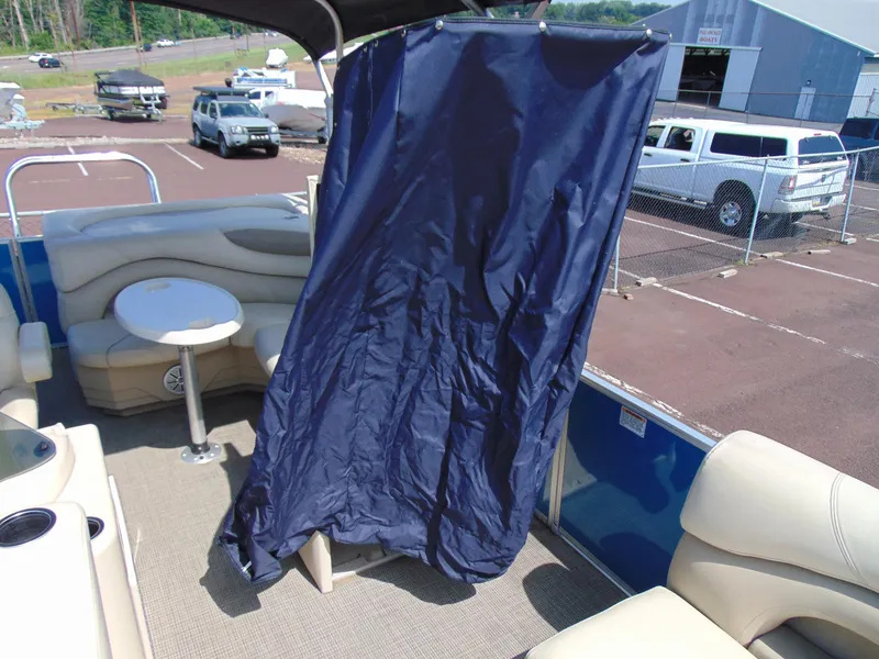 Slide: The Image of 2019 Sylvan Mirage 820 Cruise interior with seating, table, and privacy curtain. - 14