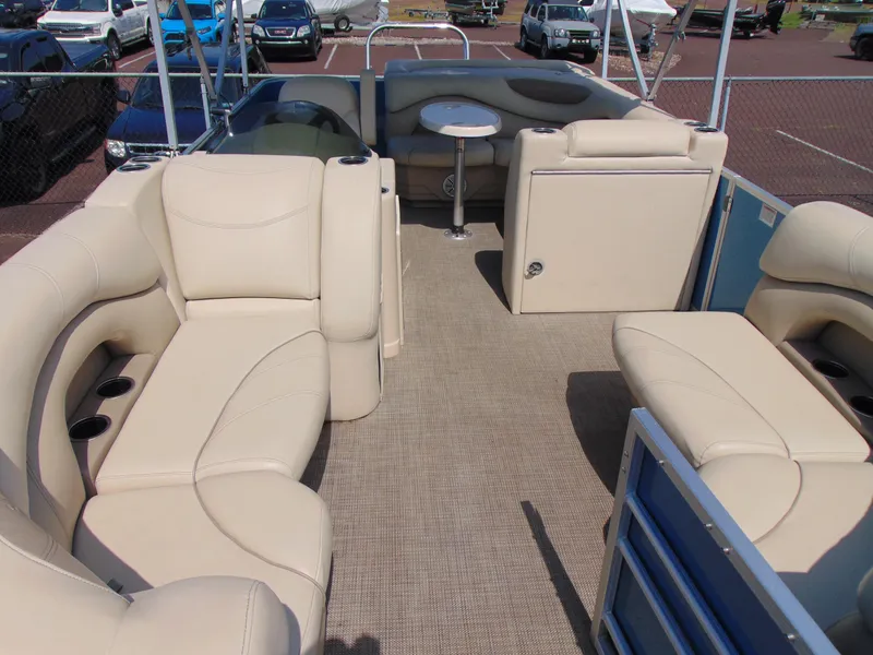 Slide: The Image of 2019 Sylvan Mirage 820 Cruise pontoon boat with beige seating and table. - 5