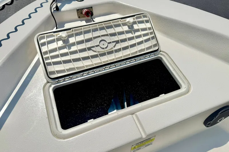 Slide: The Image of 2025 Carolina Skiff EV180 Sea Skiff open storage compartment on deck. - 10