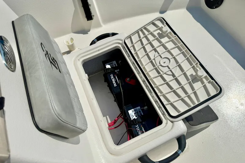 Slide: The Image of 2025 Carolina Skiff EV180 Sea Skiff battery compartment with Duracell battery visible. - 14