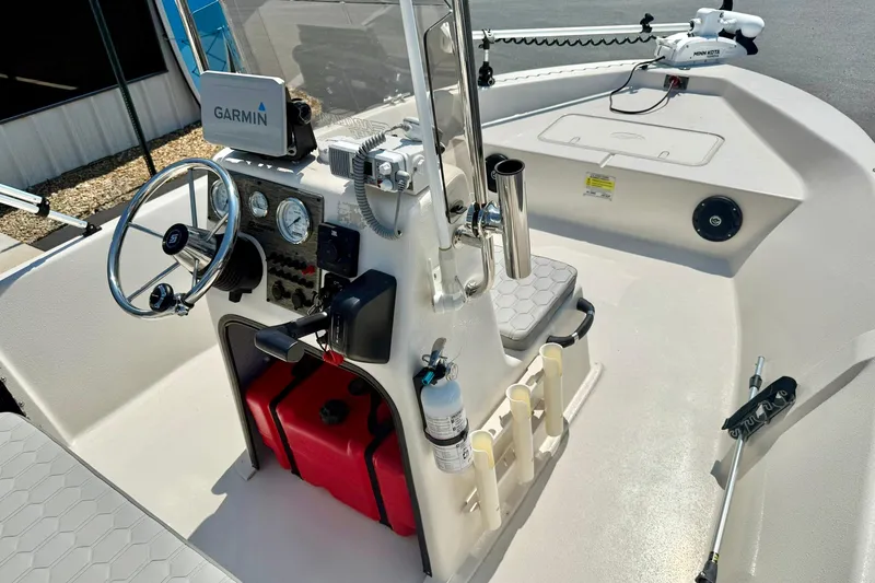 Slide: The Image of 2025 Carolina Skiff EV180 Sea Skiff boat interior with Garmin navigation system and steering console. - 15
