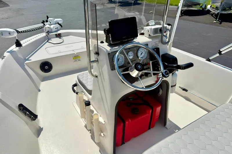 Slide: The Image of 2025 Carolina Skiff EV180 Sea Skiff interior with steering console and navigation equipment. - 16