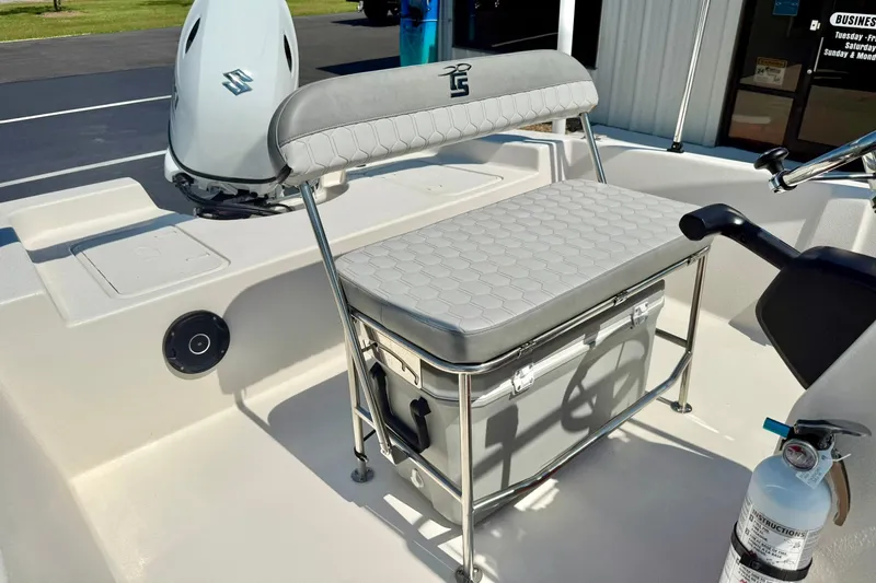 Slide: The Image of 2025 Carolina Skiff EV180 Sea Skiff interior with seating and outboard motor. - 17
