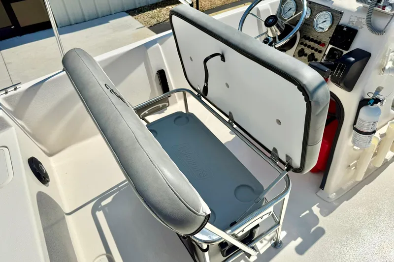Slide: The Image of 2025 Carolina Skiff EV180 Sea Skiff interior with bench seat and storage compartment. - 18