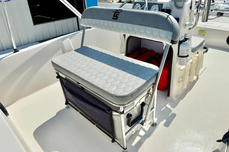 Slide: The Image of 2025 Carolina Skiff EV180 Sea Skiff interior with cushioned seating and storage. - 19