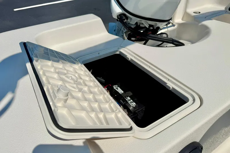 Slide: The Image of 2025 Carolina Skiff EV180 Sea Skiff battery compartment with open hatch. - 22