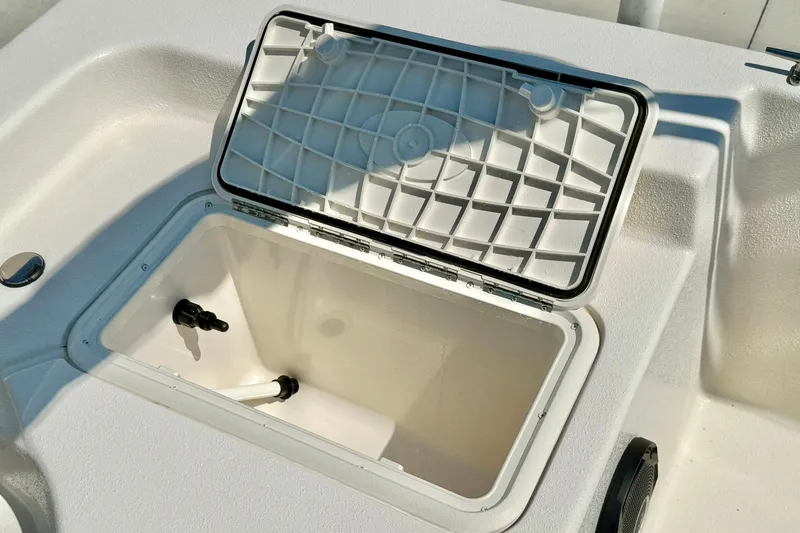 Slide: The Image of 2025 Carolina Skiff EV180 Sea Skiff storage compartment with open lid. - 23