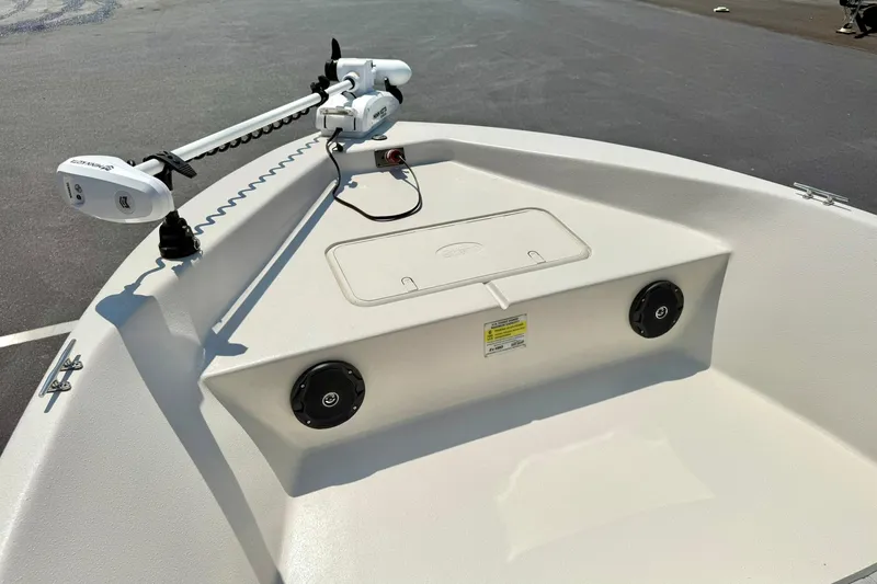 Slide: The Image of 2025 Carolina Skiff EV180 Sea Skiff bow with trolling motor and storage compartment. - 9