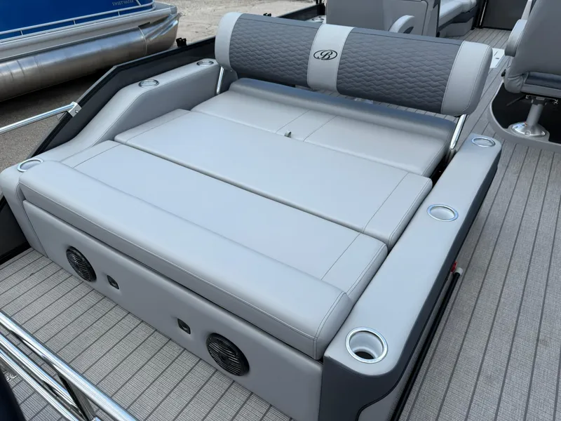 Slide: The Image of 2026 Bentley Pontoons Elite 253 Swingback with luxurious seating and integrated speakers. - 13