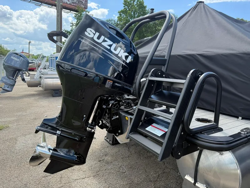 Slide: The Image of 2026 Bentley Pontoons Elite 253 Swingback with Suzuki outboard motor, docked outdoors. - 4