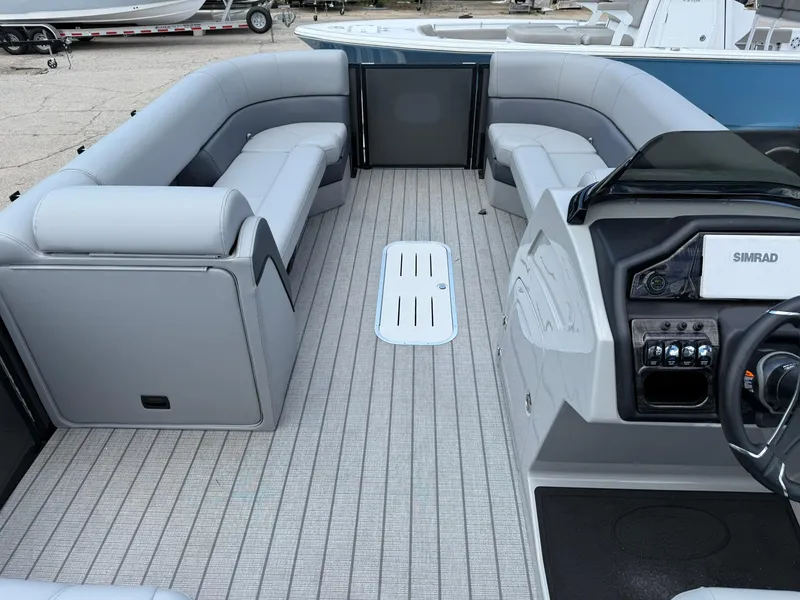 Slide: The Image of 2026 Bentley Pontoons Elite 253 Swingback interior with luxurious seating and modern dashboard. - 8