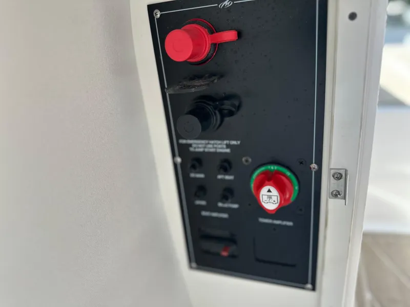 Slide: The Image of Control panel of 2024 Monterey M-65 boat with red and green switches. - 17