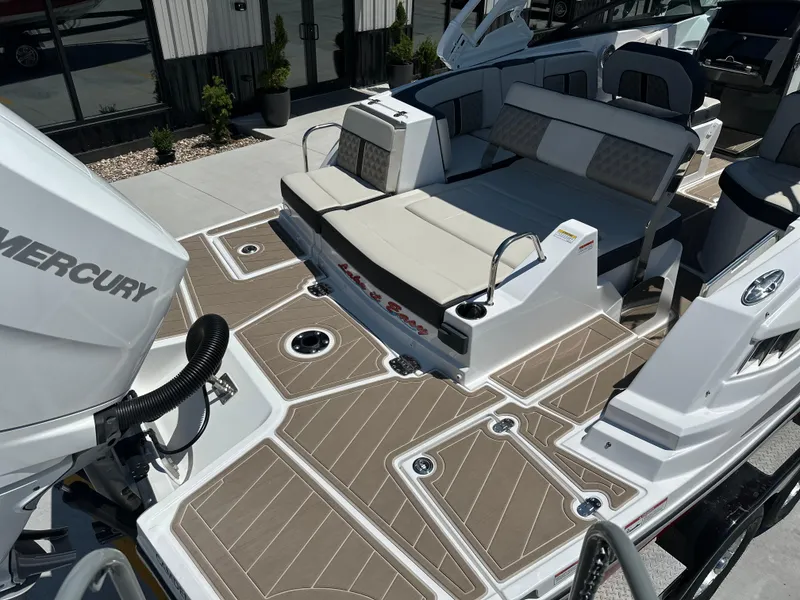 Slide: The Image of 2024 Monterey M-65 boat with spacious seating and Mercury engine, featuring sleek deck design. - 3