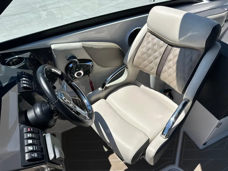 Slide: The Image of 2024 Monterey M-65 boat cockpit with luxury steering and quilted seat design. - 8