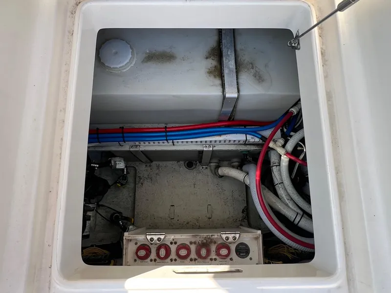 Slide: The Image of 2007 Pursuit OS 285 Offshore boat compartment with wiring and control panel. - 10