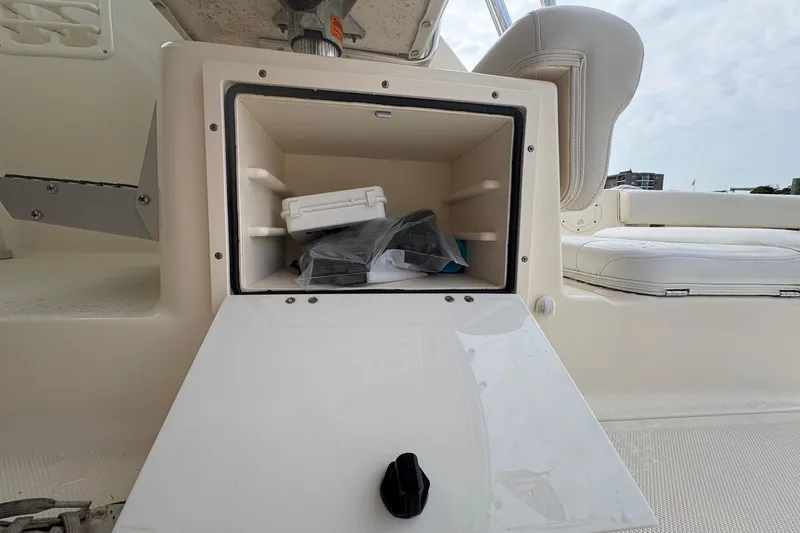 Slide: The Image of Open storage compartment on 2007 Pursuit OS 285 Offshore boat, showing interior contents. - 20