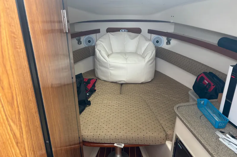 Slide: The Image of 2007 Pursuit OS 285 Offshore cabin interior with seating and storage. - 22