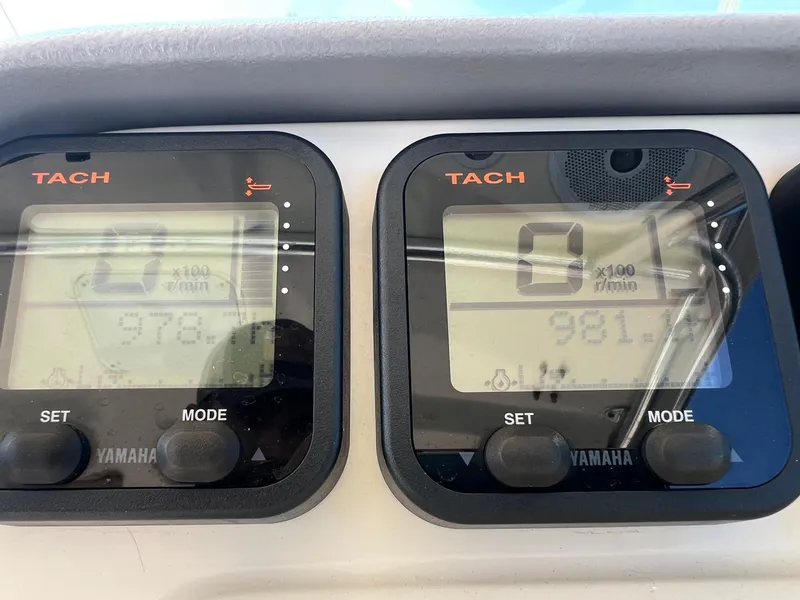 Slide: The Image of Digital tachometers on a 2007 Pursuit OS 285 Offshore boat dashboard. - 9