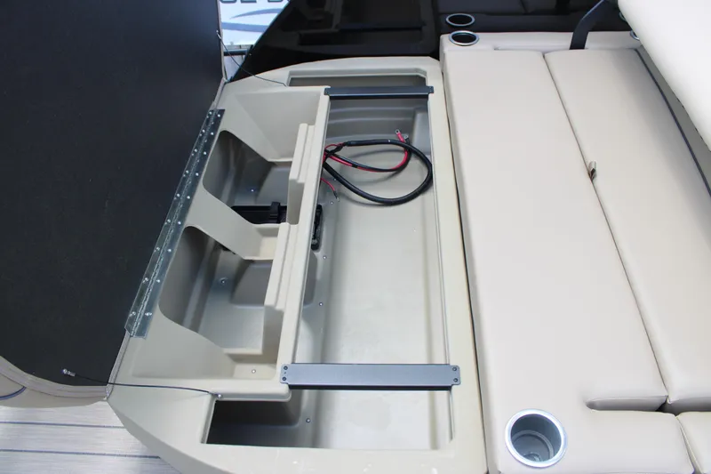 Slide: The Image of Open storage compartment in 2026 Starcraft EXS 1 Q DH boat with cup holders. - 13