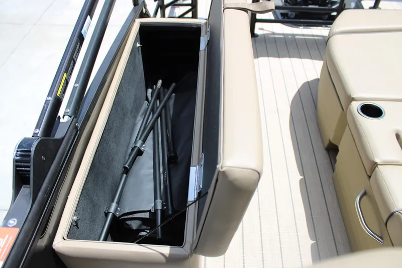 Slide: The Image of 2026 Starcraft EXS 1 Q DH boat storage compartment with beige seating and cup holder. - 14
