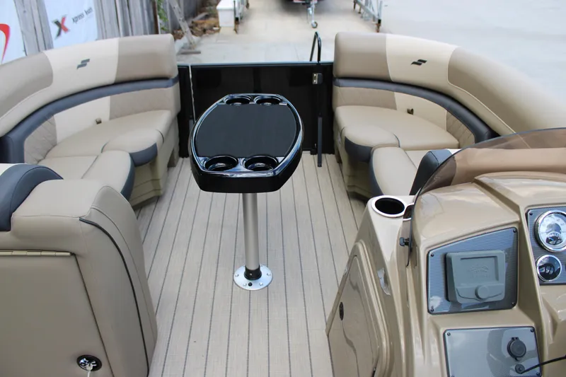 Slide: The Image of 2026 Starcraft EXS 1 Q DH boat interior with beige seating and central table. - 17