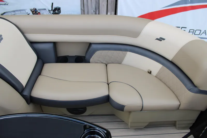 Slide: The Image of Luxurious seating on 2026 Starcraft EXS 1 Q DH boat, featuring beige and gray upholstery. - 19