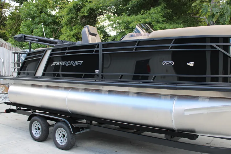 Slide: The Image of 2026 Starcraft EXS 1 Q DH pontoon boat on trailer, sleek black design. - 4