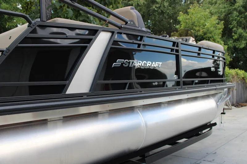 Slide: The Image of 2026 Starcraft EXS 1 Q DH pontoon boat with sleek black design and modern features. - 6